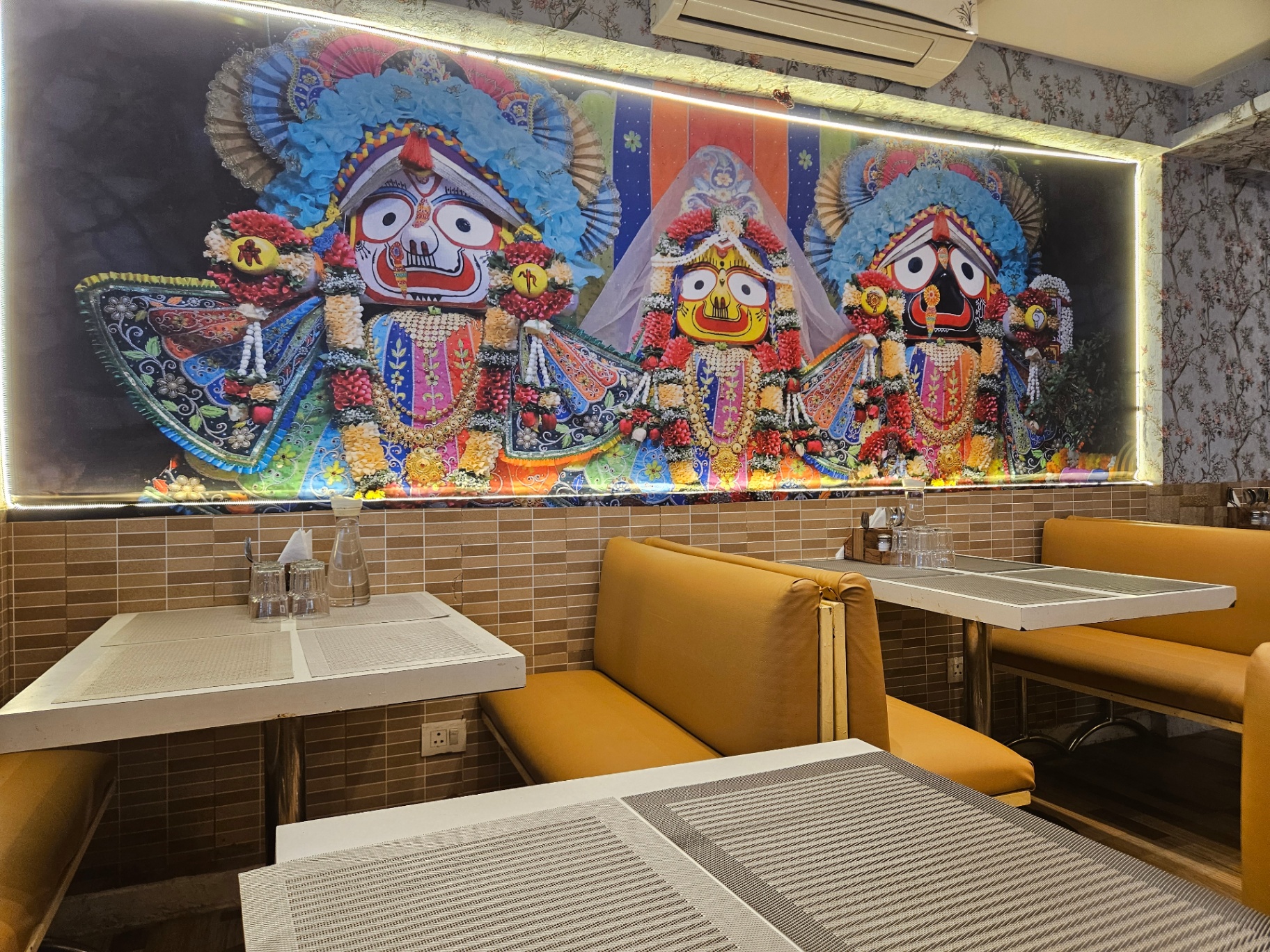 Illuminated devotional artwork above seating