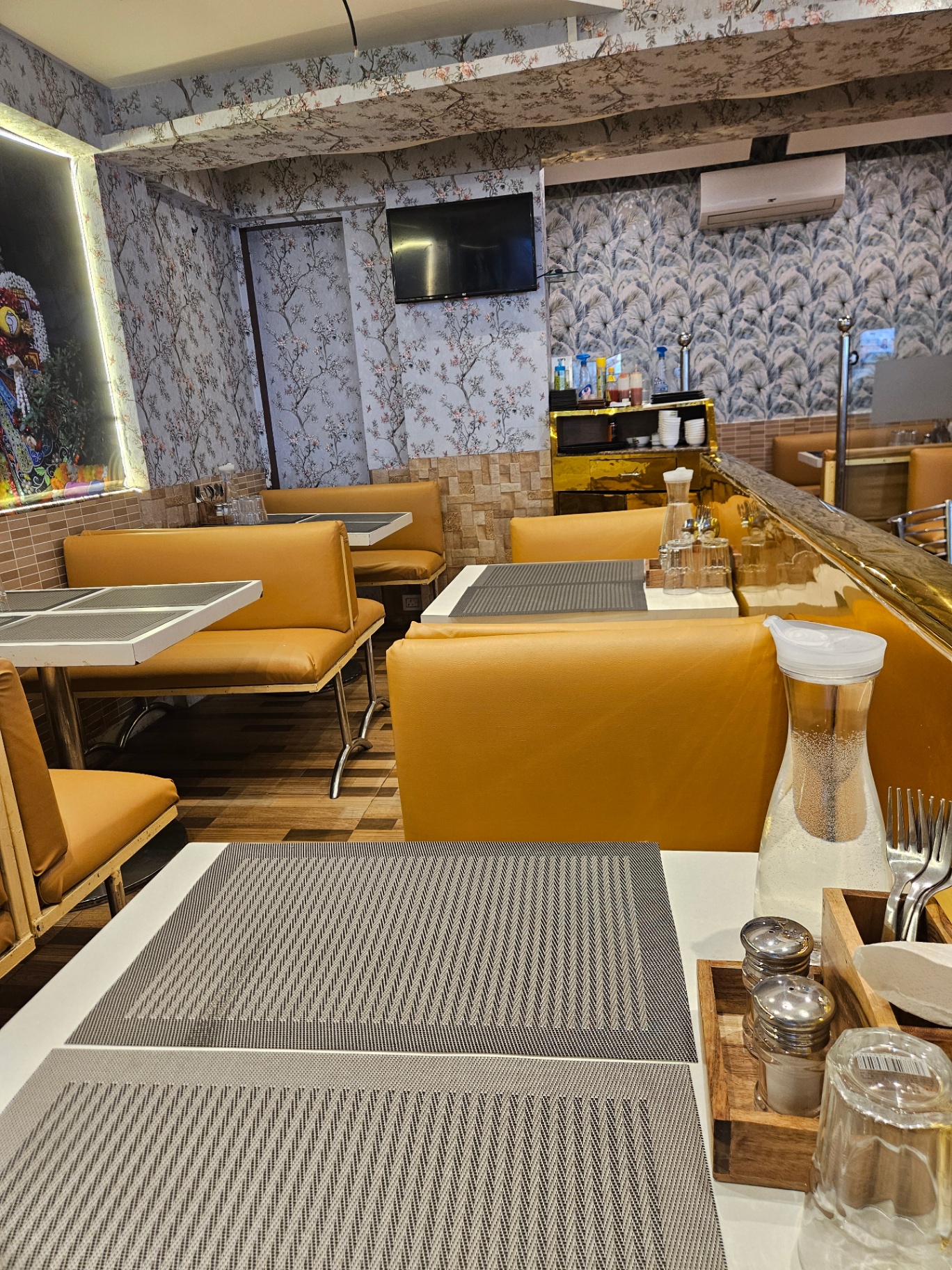 Booth seating with floral wallpaper