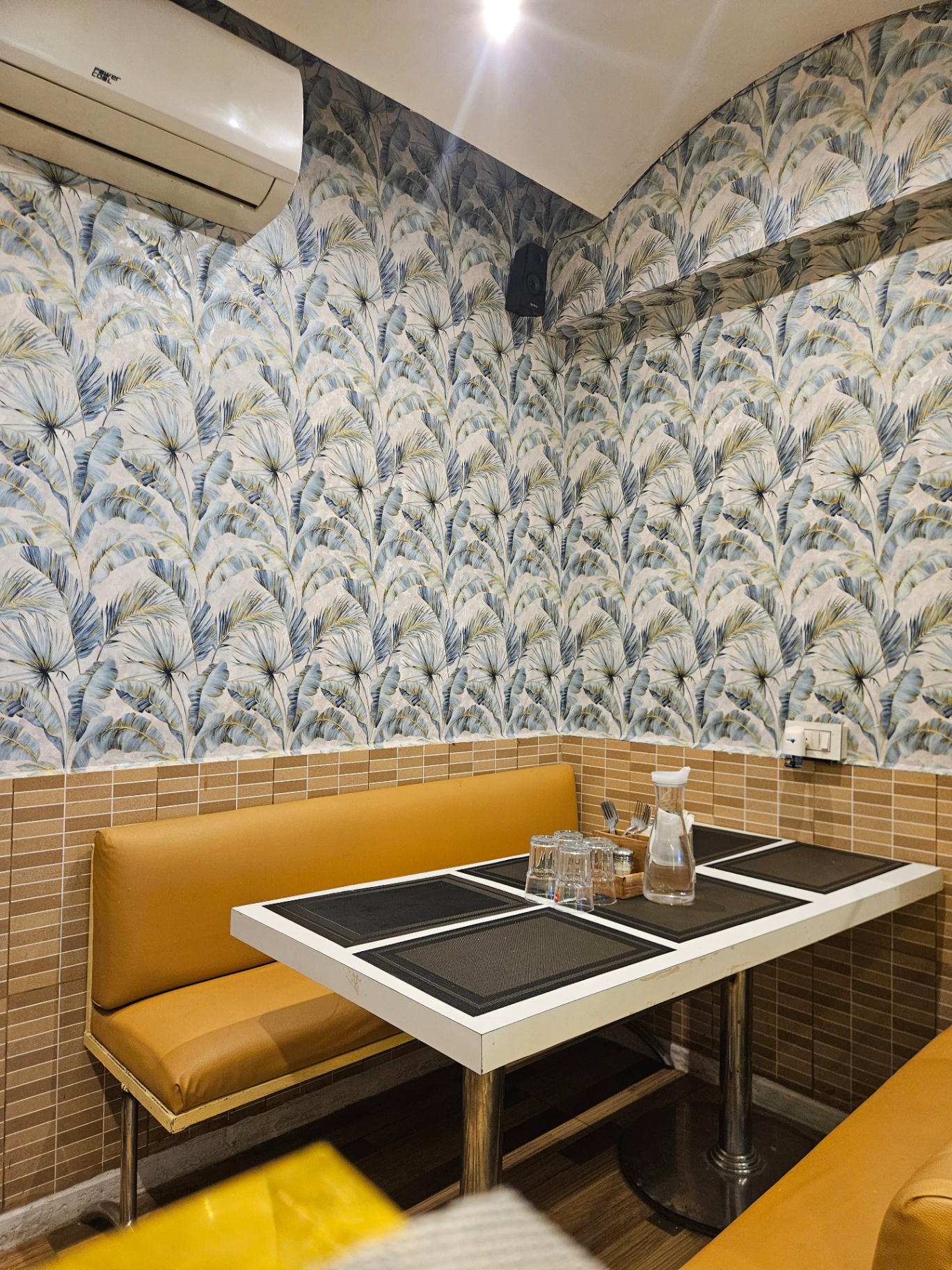 Quiet corner table with banana-leaf wallpaper