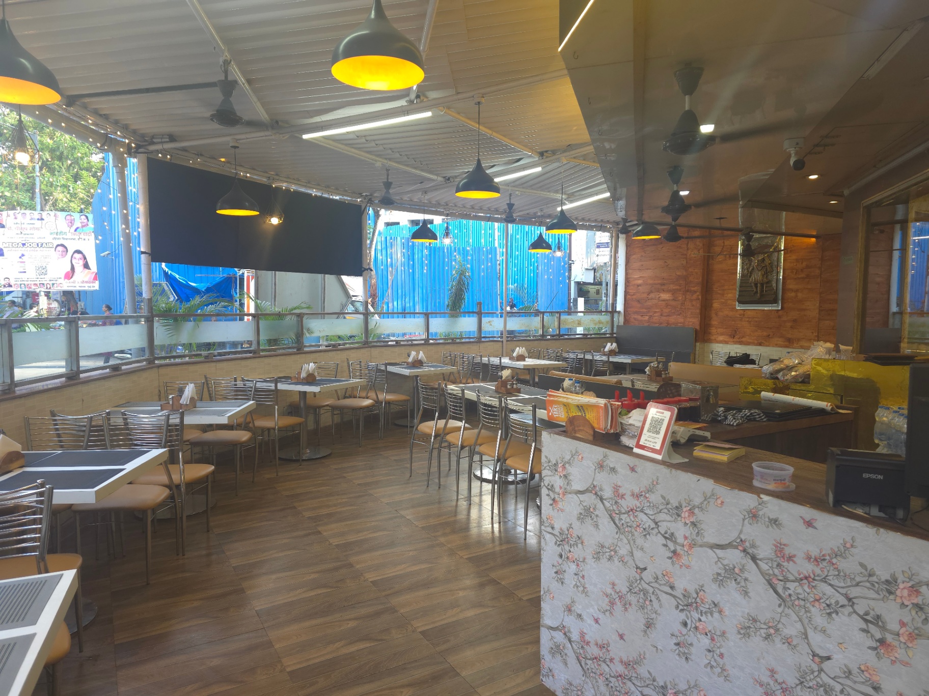 Radhey Krishana dining terrace with pendant lights and floral counter