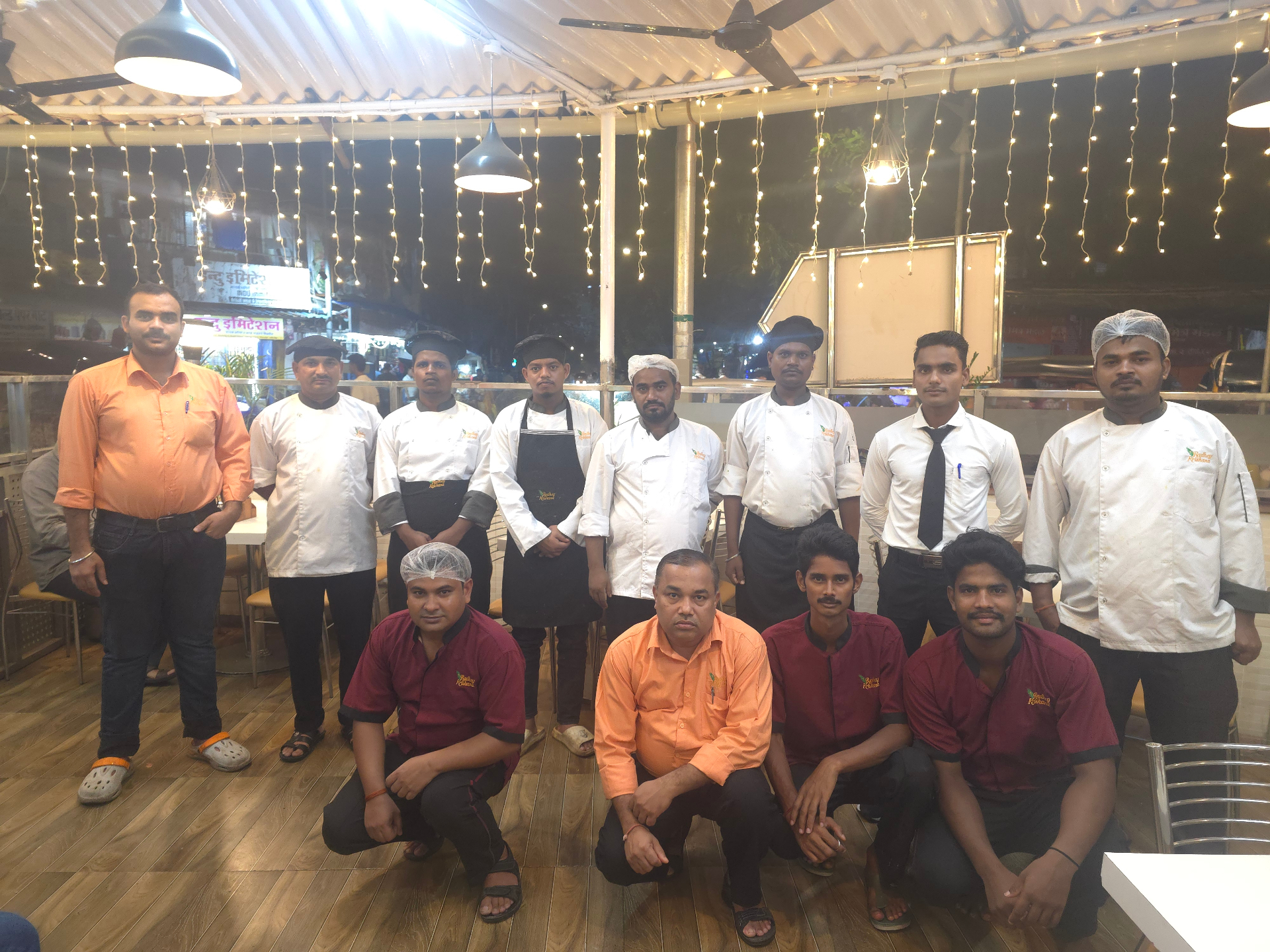 The Radhey Krishana chefs and hospitality team under fairy-lit ceiling in Dahisar East